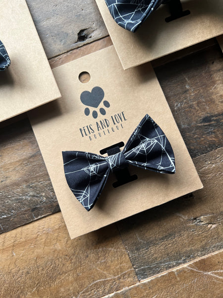 A black bow tie with a white spider web pattern