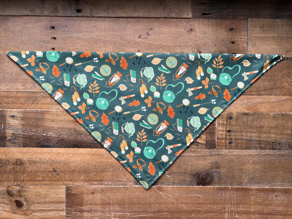 Wilderness Supplies on a Dark Green Background Dog Bandana
