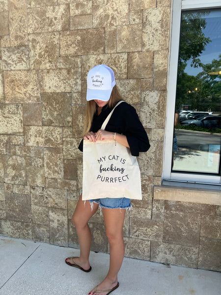 Person holding a Bag with My Dog Is Cat is fucking purrfect text