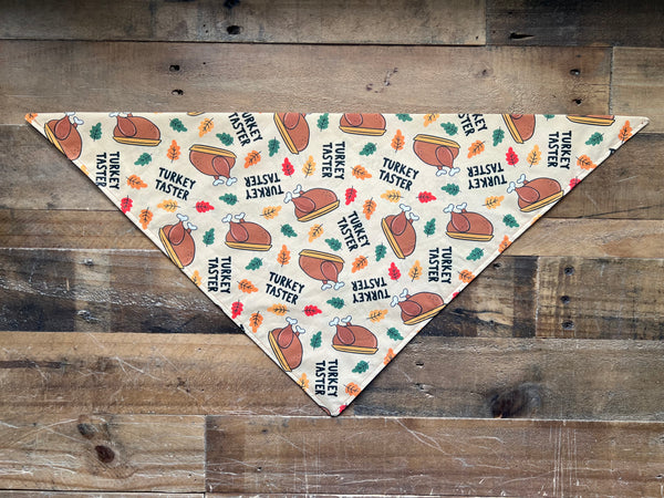 Turkey Taster Saying with Turkeys and Leaves Pattern on a beige background dog bandana